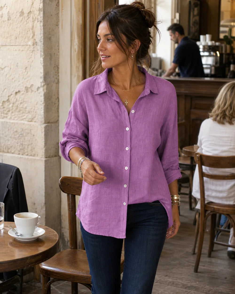Women's purple cotton-linen relaxed shirt in a café lifestyle setting.