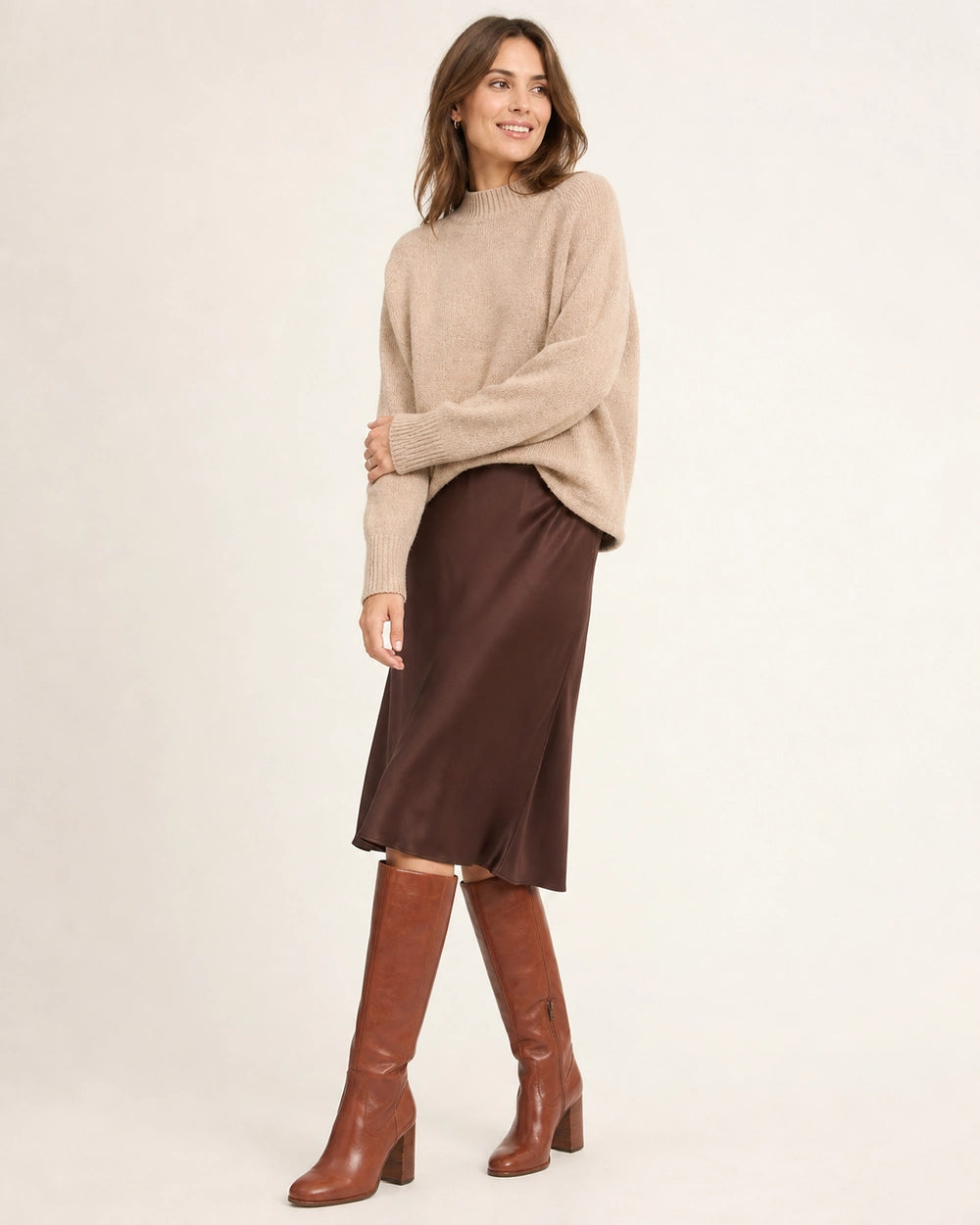 Women's cognac-brown knee-high boots with a sculpted block heel, full silhouette.