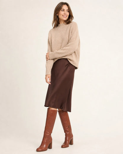 Women's cognac-brown knee-high boots with a sculpted block heel, full silhouette.