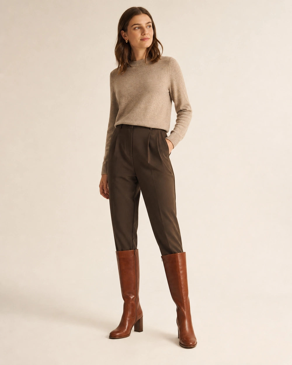 Women's cognac-brown knee-high boots with tailored styling.