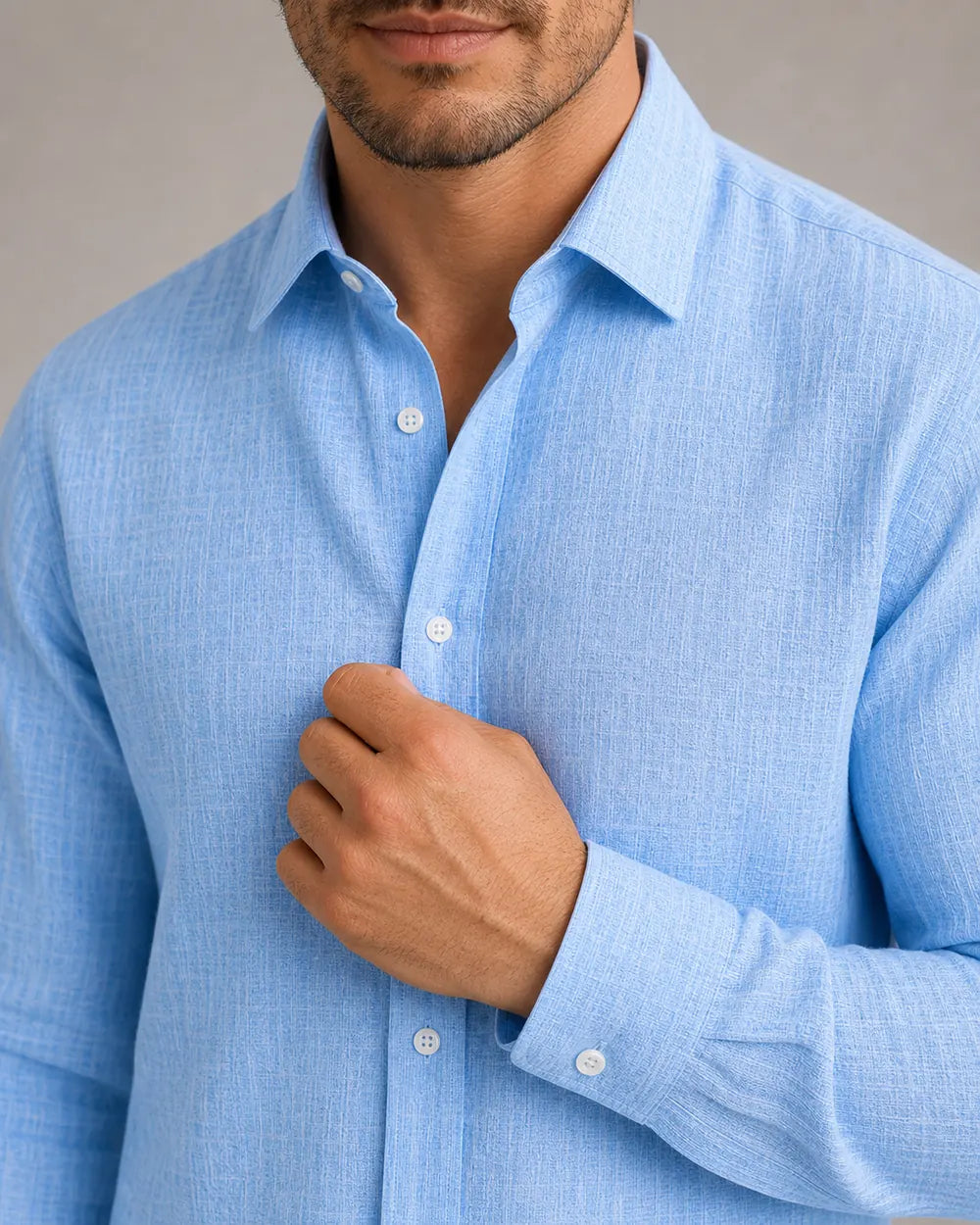 Men's light blue summer shirt, collar, button, cuff and textured weave detail.