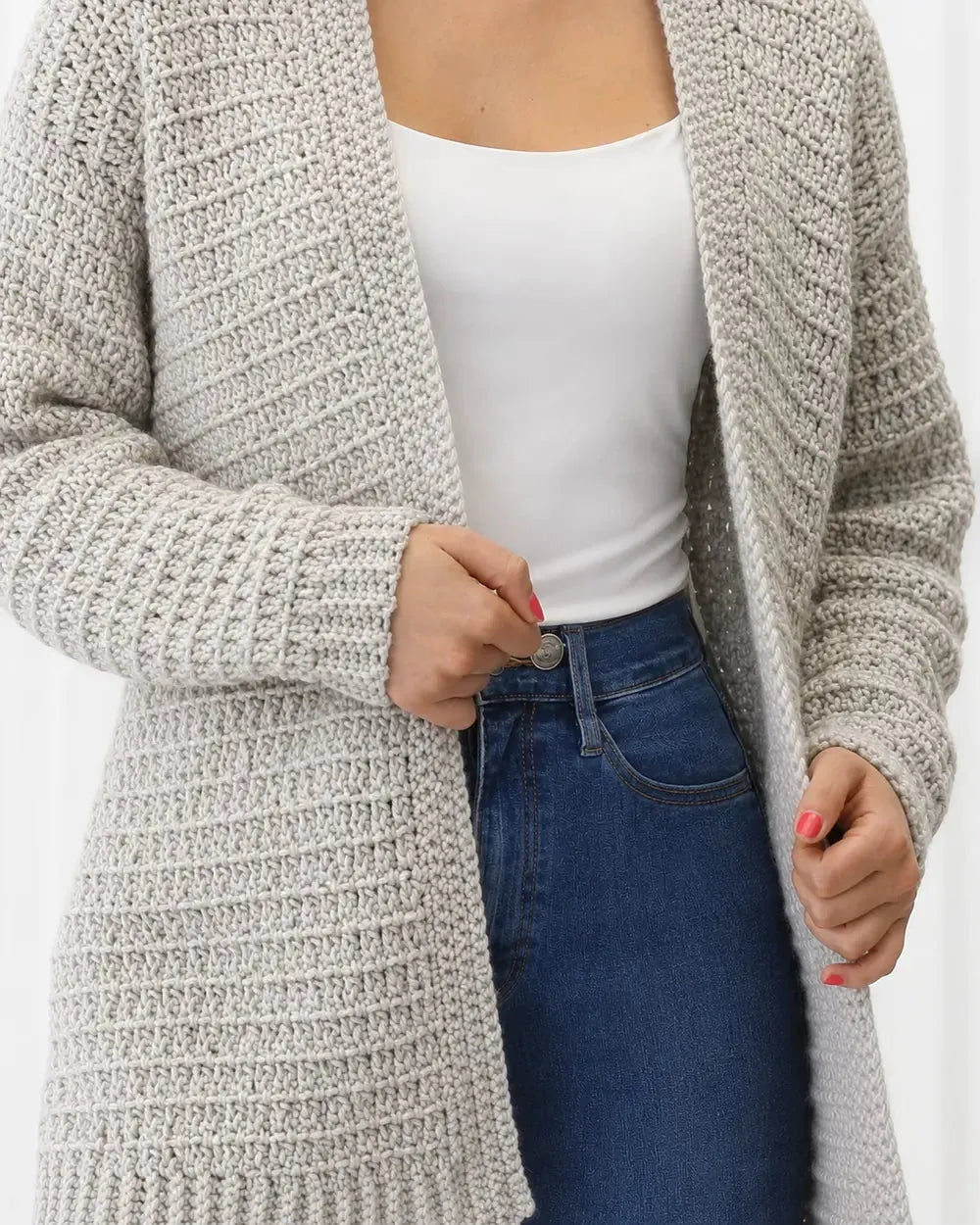 Close-up of the grey crochet texture, edge and long sleeve.