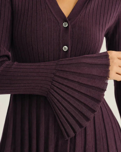 Close-up of the purple rib knit, buttons and flared cuff.