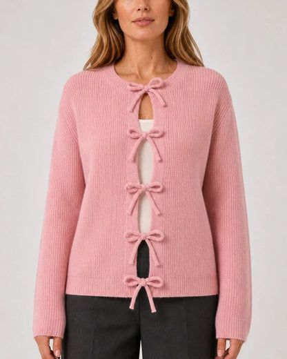Pink ribbed cardigan with tonal bow ties, straight front fit.