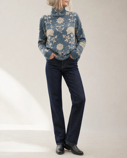 Women's slate blue floral turtleneck sweater styled with dark denim