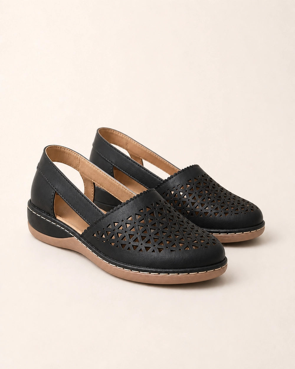 Pair of black perforated slingback shoes.