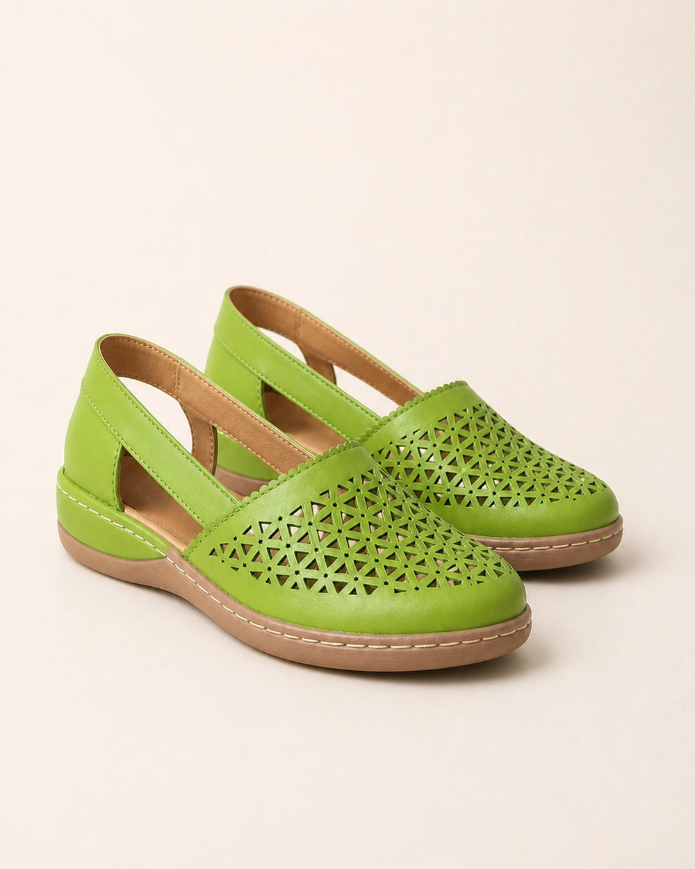 Pair of light green perforated slingback shoes.