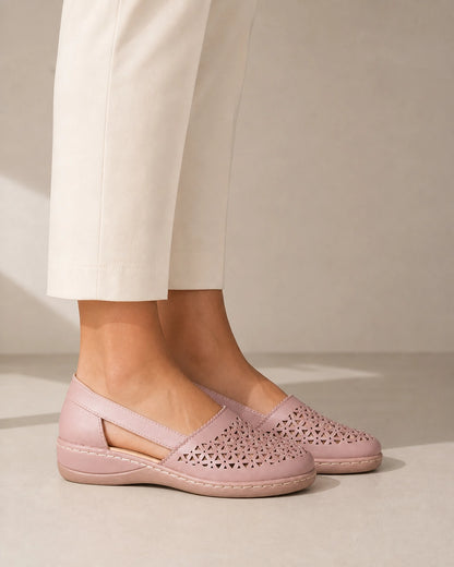 Women's light pink perforated shoes, lateral profile.