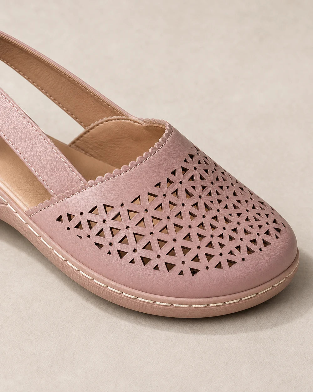 Light pink perforated shoe, upper and stitching detail.