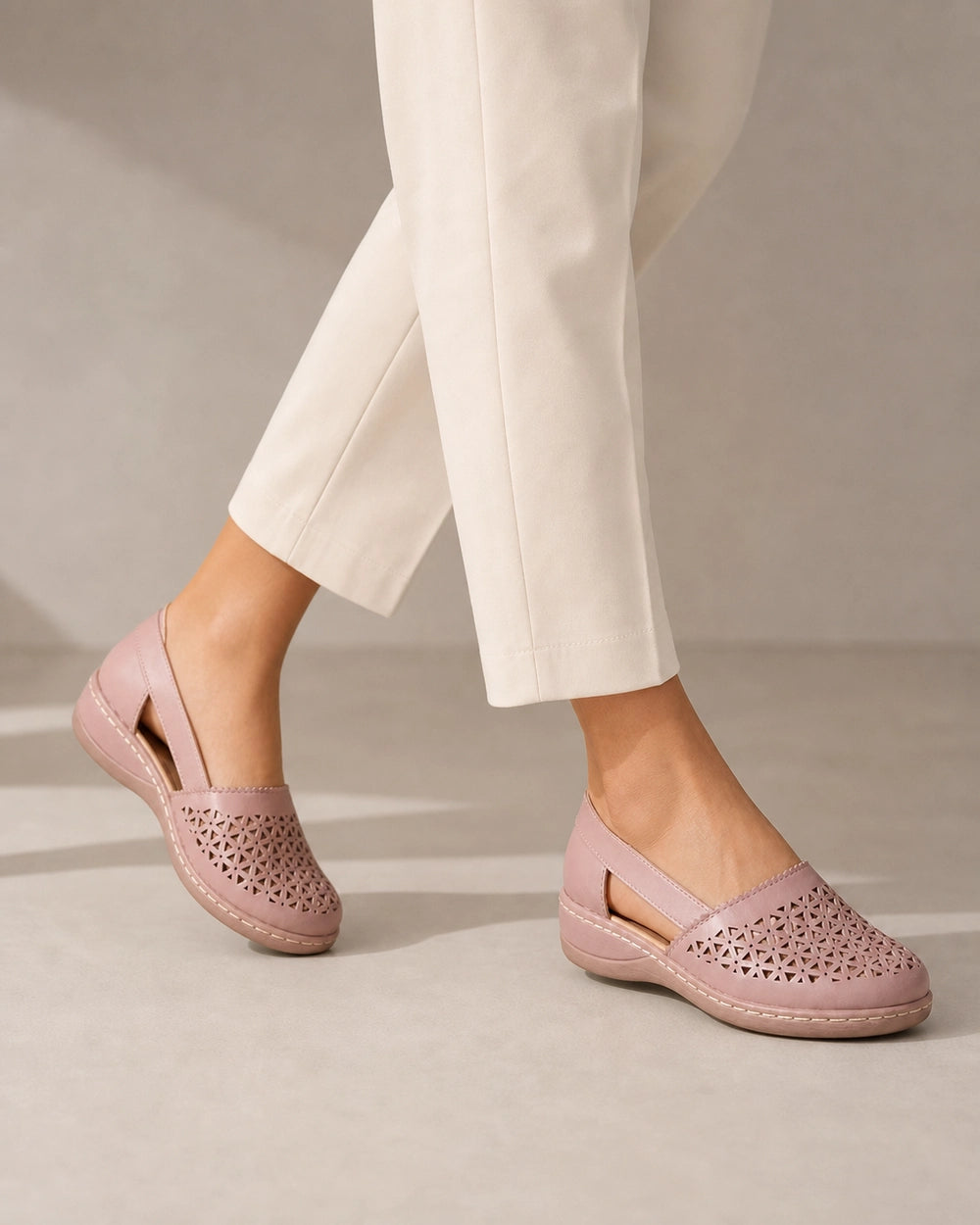 Women's light pink slingback shoes, walking view.
