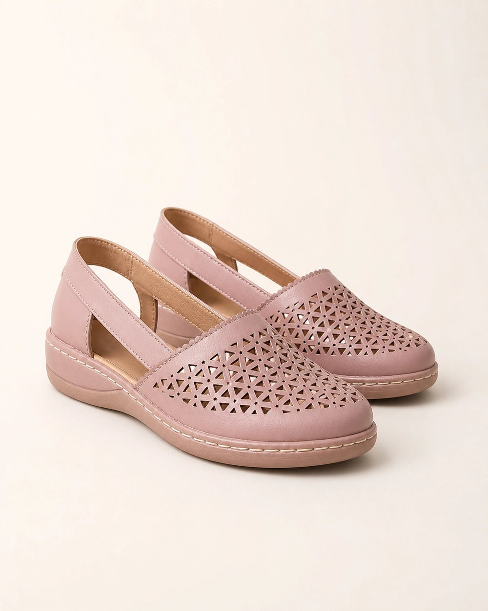 Pair of light pink perforated slingback shoes, product-only view.