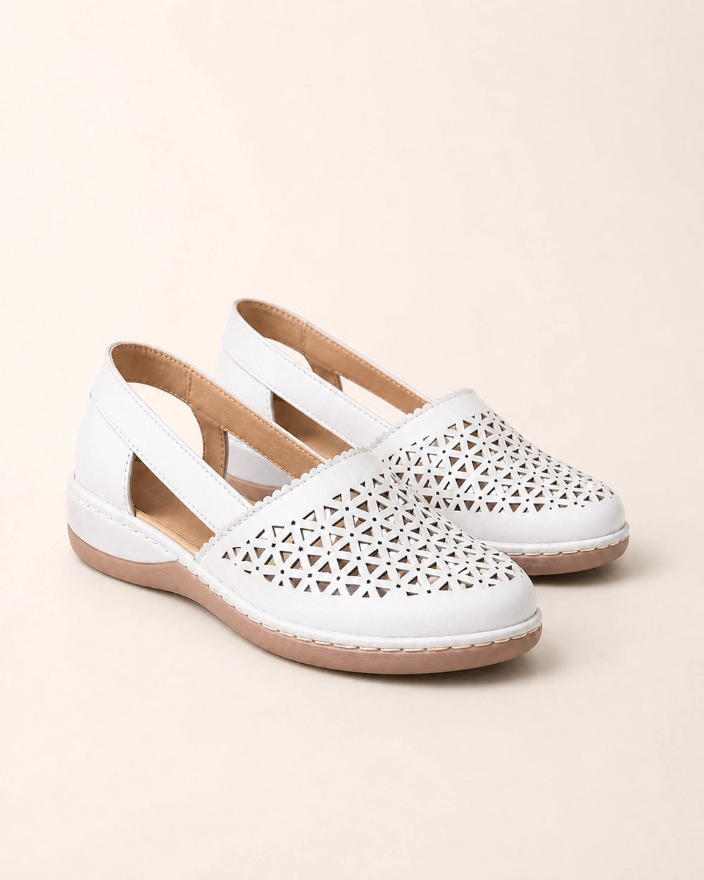 Pair of white perforated slingback shoes.
