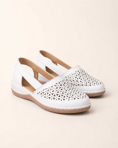 Pair of white perforated slingback shoes.