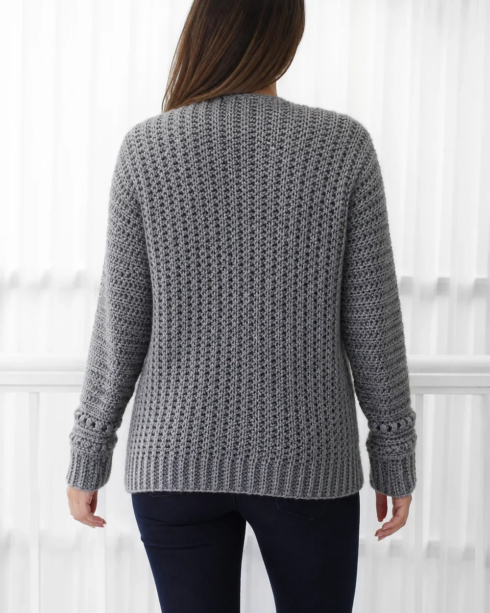 Grey openwork crochet cardigan, rear construction view.