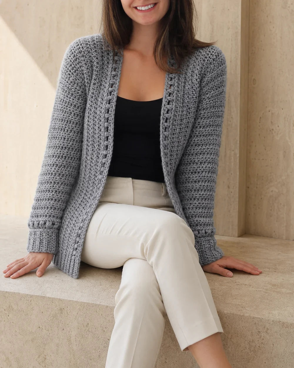 Grey bobble-texture cardigan for women, relaxed seated styling.
