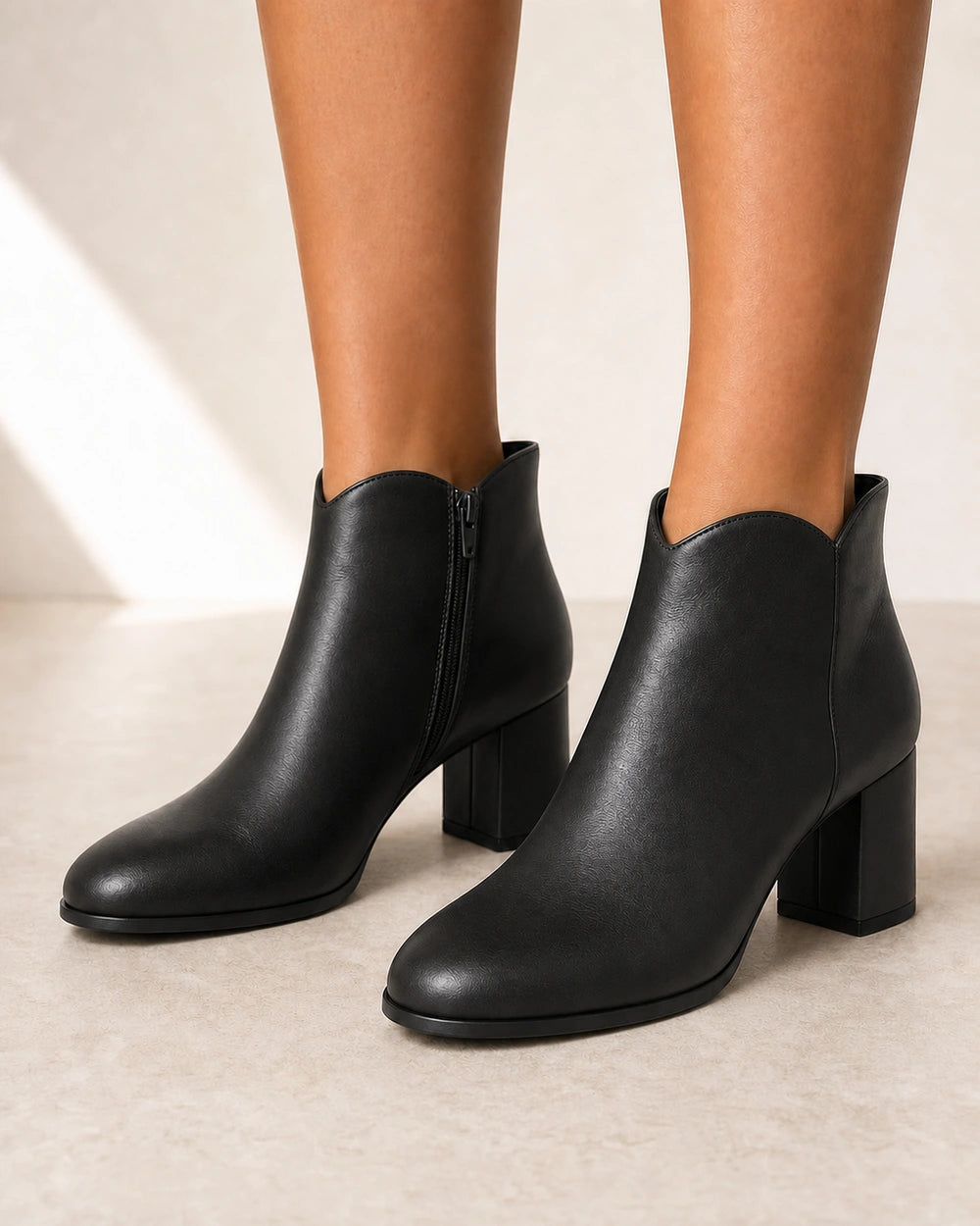 Women's black American-style chunky-heel ankle boots, front three-quarter view.