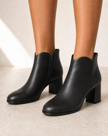 Women's black American-style chunky-heel ankle boots, front three-quarter view.
