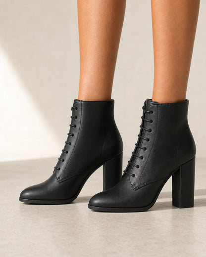 Women's black lace-up high-heel ankle boots, lateral profile.