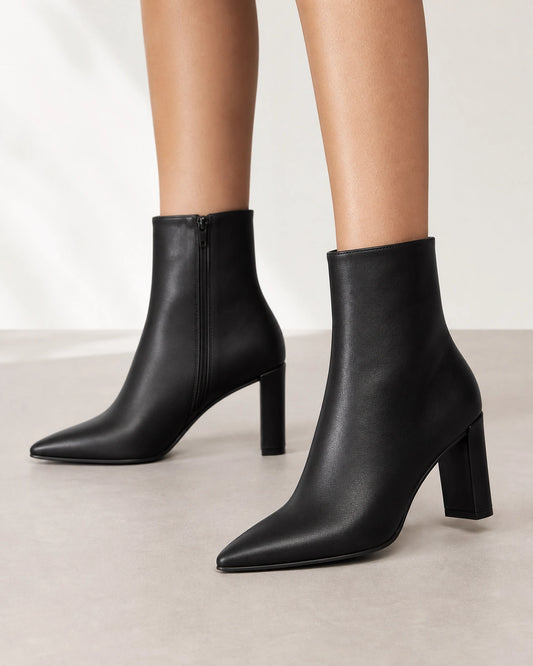 Women's black pointed-toe high-heel ankle boots, front three-quarter view.