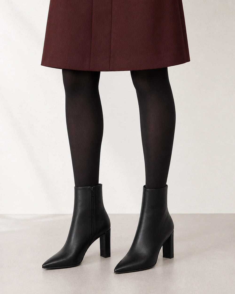 Women's black pointed-toe high-heel ankle boots, second styling view.