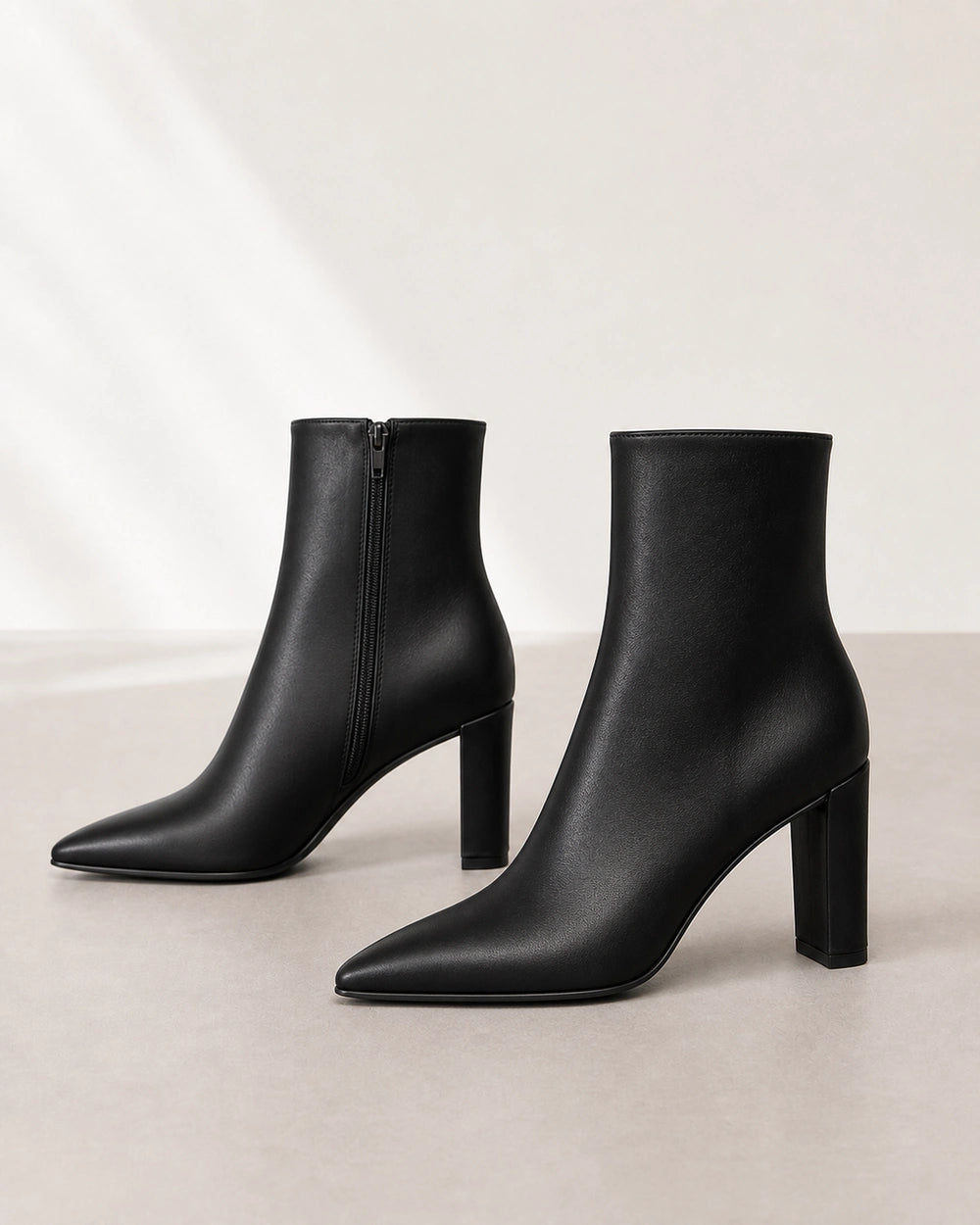 Women's black pointed-toe high-heel ankle boots, product-only view.
