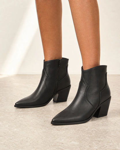 Women's black pointed western ankle boots, front three-quarter view.