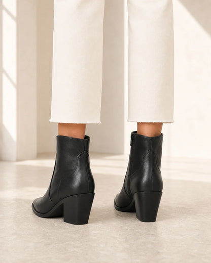 Women's black pointed western ankle boots, rear view.
