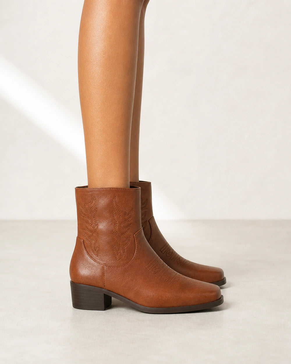Women's brown square-toe western ankle boots, lateral profile.