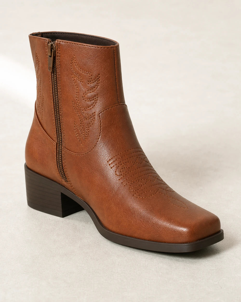 Women's brown square-toe western ankle boots, construction detail.