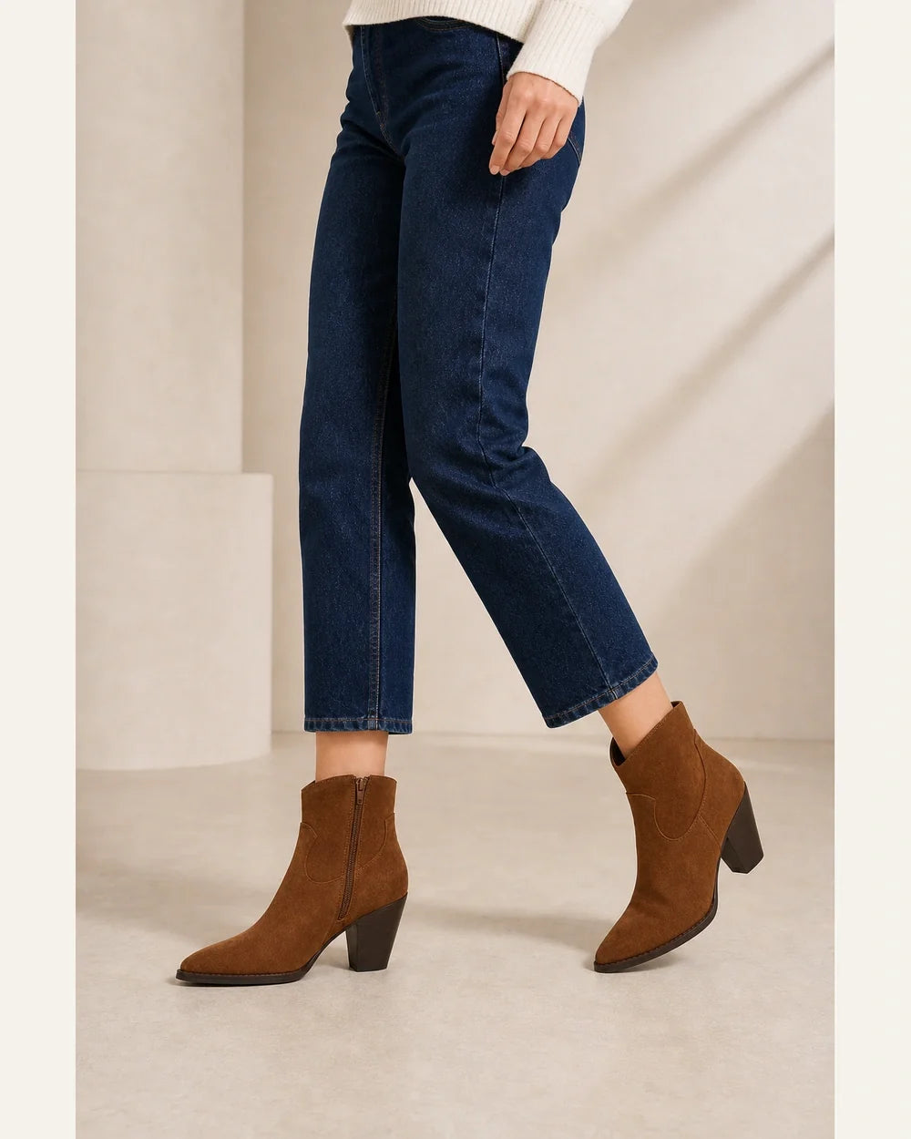 Brown suede western ankle boots, walking view without distortion.