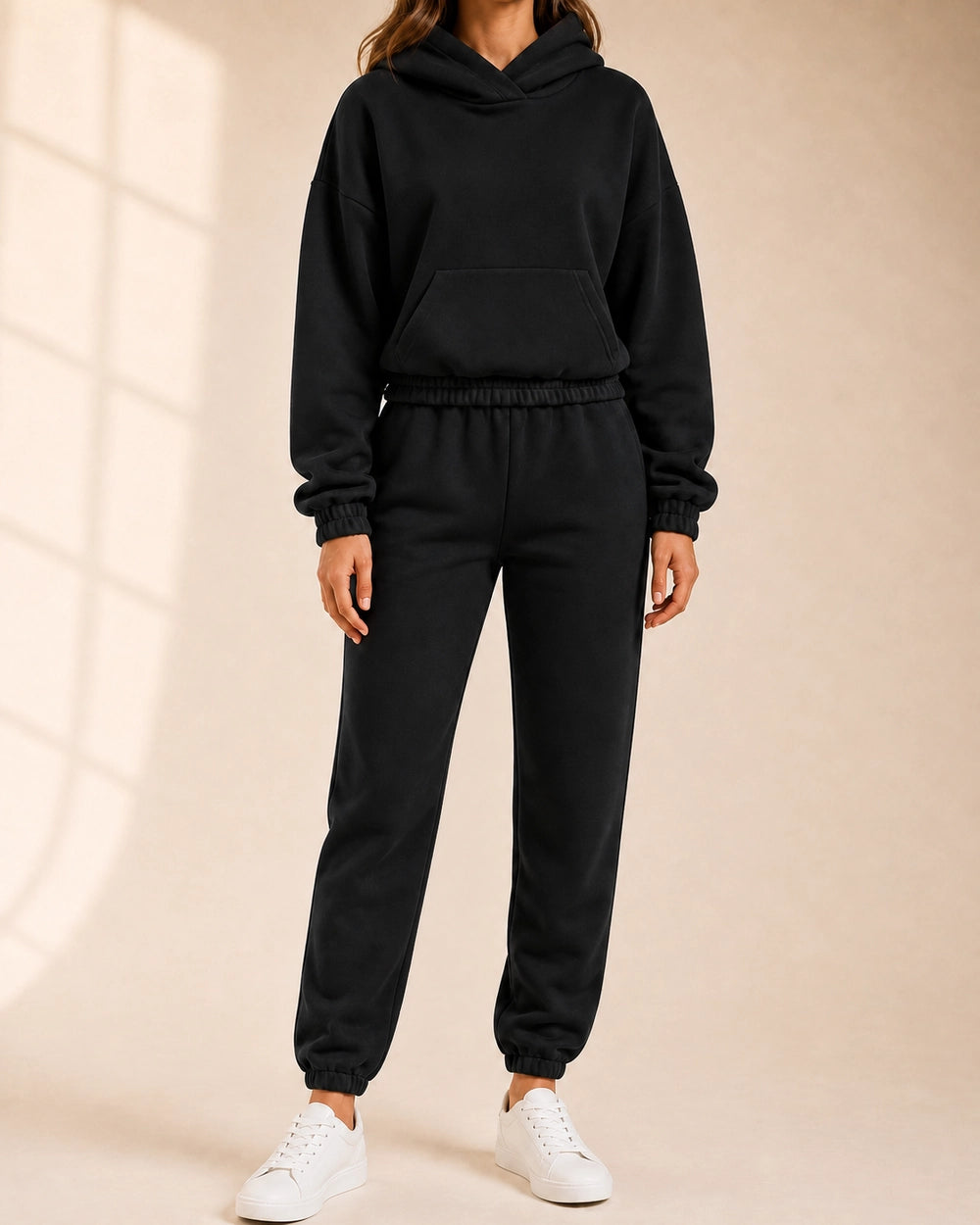 Women's black hooded two-piece jogger set, front view.