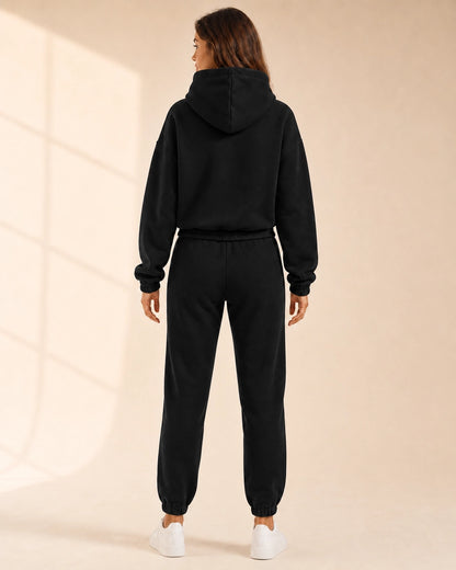 Women's black hooded two-piece jogger set, rear view.