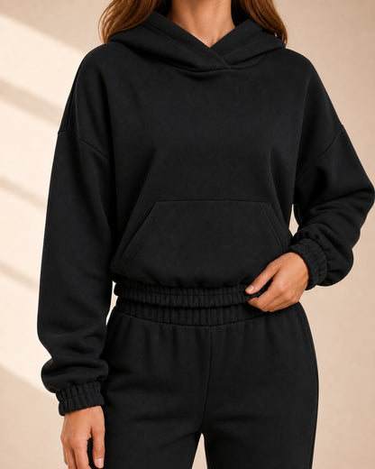 Women's black hooded jogger set, neckline and elasticated waist detail.