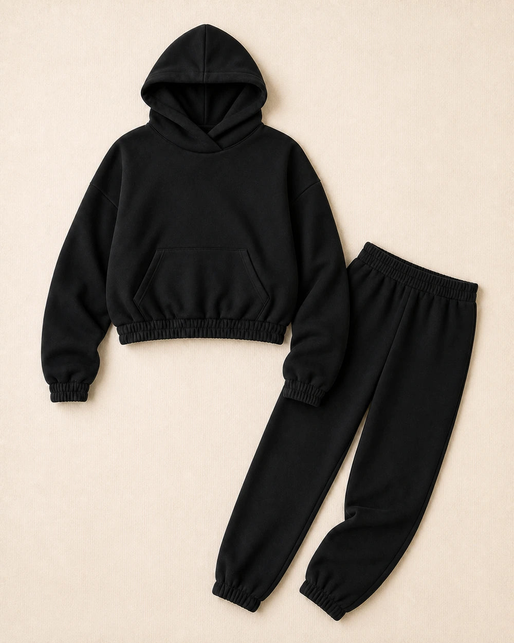 Women's black hooded sweatshirt and matching joggers, product-only view.