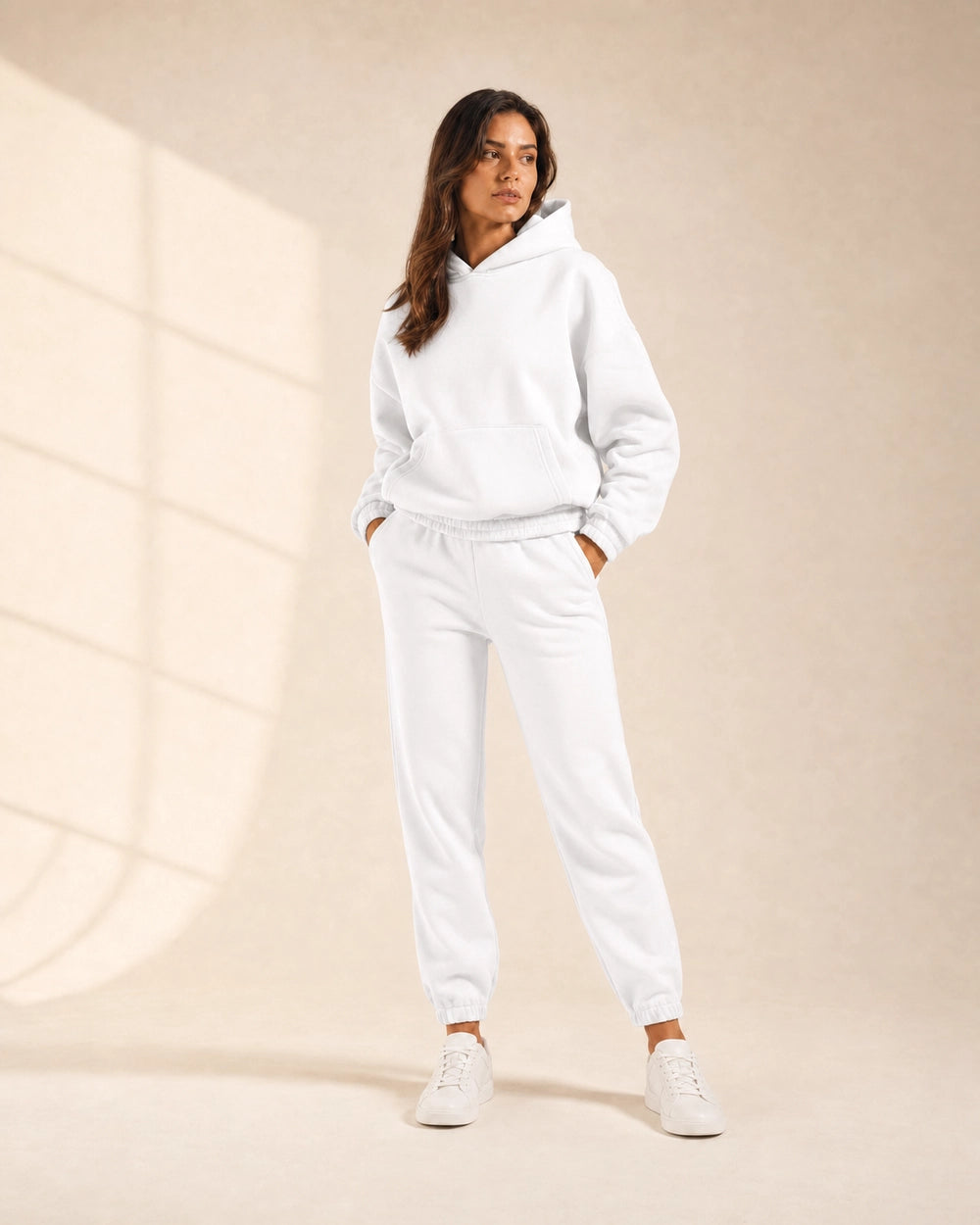 Women's white hooded two-piece jogger set, front view.