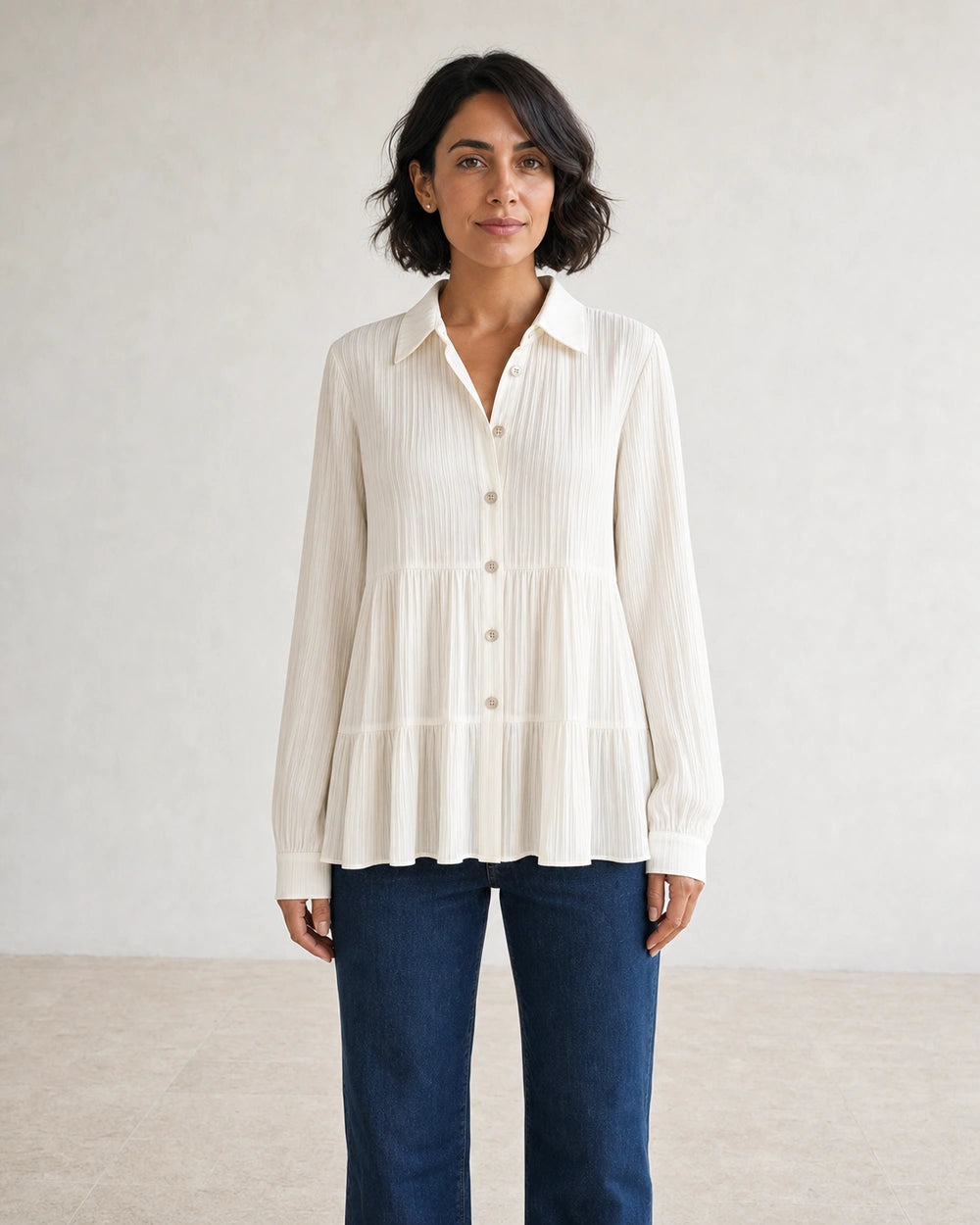 Women's milk-white pleated peplum shirt, straight front fit.