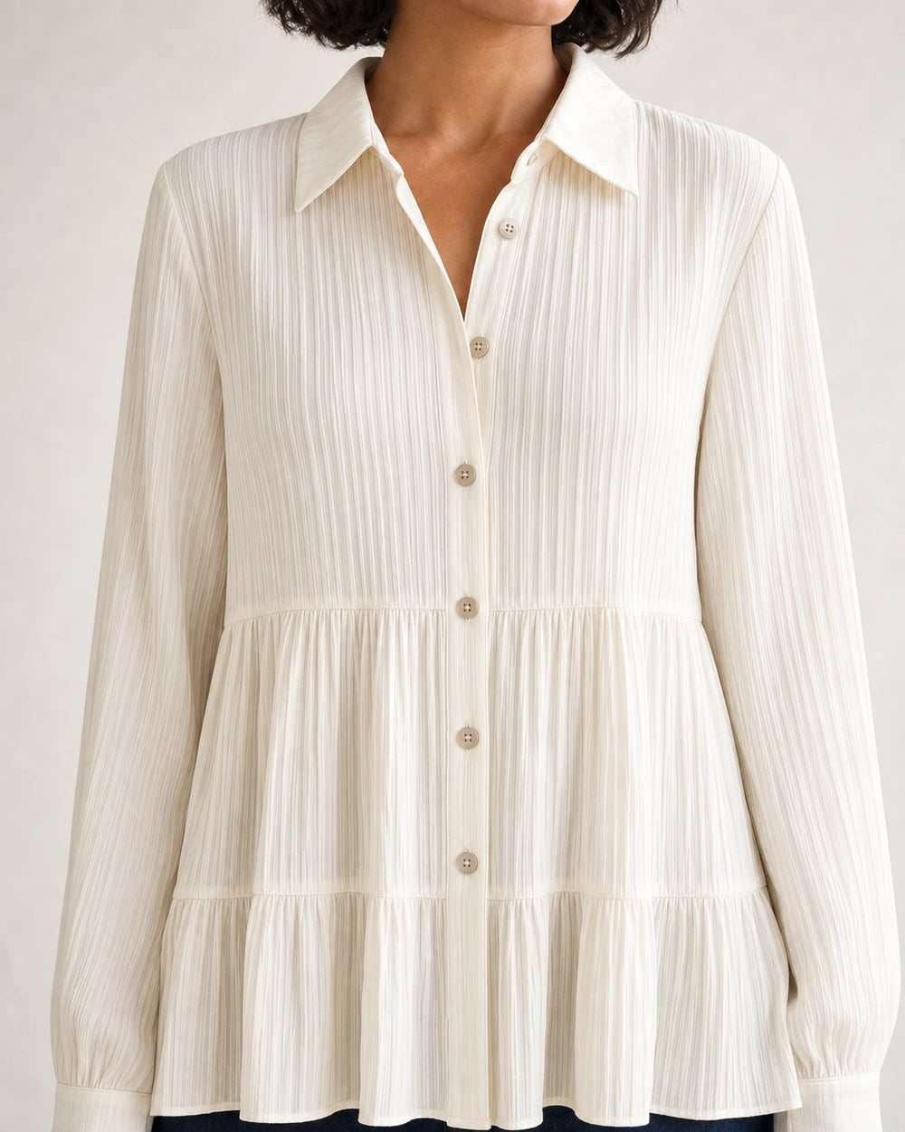 Milk-white pleated peplum shirt, collar, buttons and waist detail.