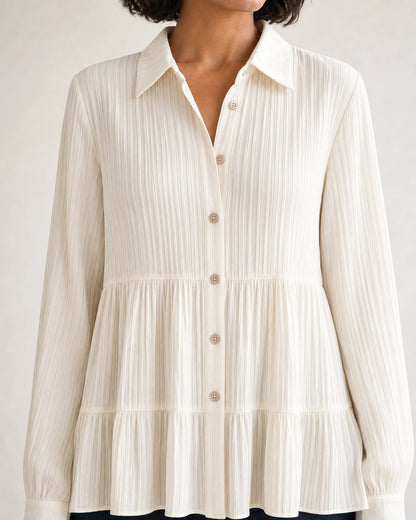 Milk-white pleated peplum shirt, collar, buttons and waist detail.