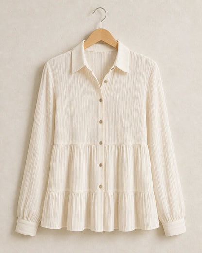 Milk-white pleated peplum shirt, product-only hanger view.