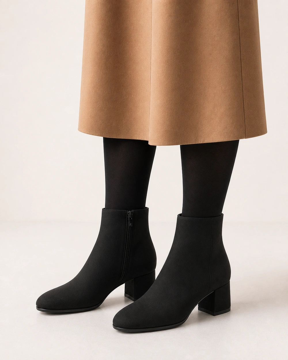Women's minimalist black block-heel ankle boots, second styling view.