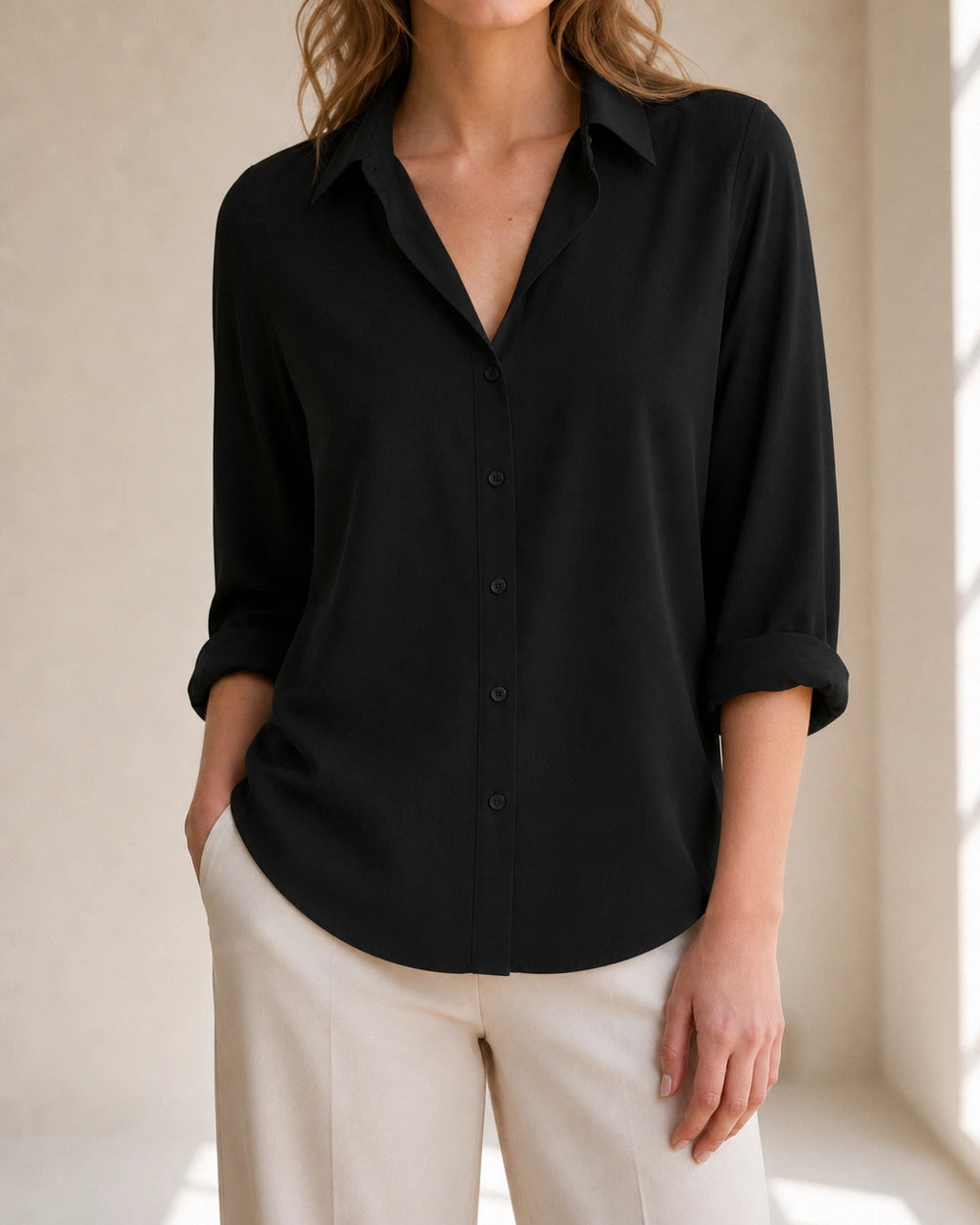 Women's black relaxed button-front blouse, front product view.